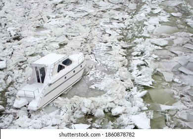 Close Up Of A Small White Boat Trapped In A Iced Frozen River Danube In Novi Sad,Serbia.Harsh Weather Conditions In Winter Time.Broken Ice Texture,copy Space,top View,aerial View.