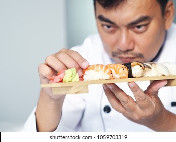 Close up smart master chef hands making a sushi in the kitchen.