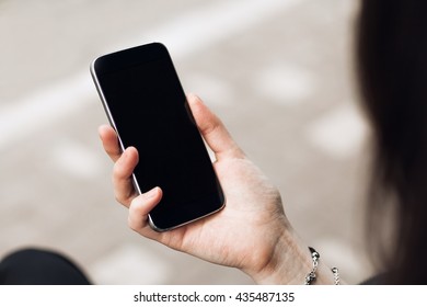 Close Up Of Smart Phone In Girl's Hand