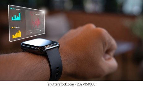 Close Up Smart Watch On The Wrist Of A Man Who Is Exercising Tells His Heart Rate. Step Count And Calories Burned. Technology And Healthcare Concept.