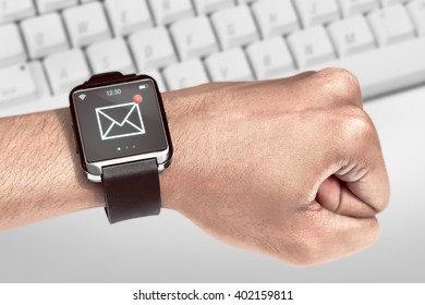 Close up smart watch with unread message icon on the screen is on hand - Powered by Shutterstock