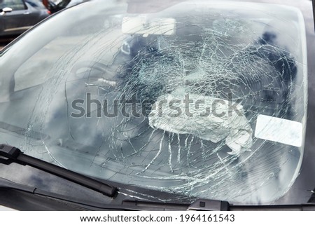 Close up of smashed windscreen on vandalised car