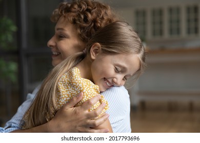 Close Up Smiling Adorable Little Daughter With Closed Eyes And Loving Mother Hugging Enjoying Tender Moment, Caring Happy Mom With Preschool Kid Child Embracing, Good Warm Family Relationship Concept