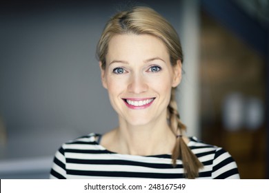 Close Up Of A Smiling Blond Woman Wearing A Striped Shirt