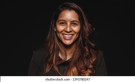 Close Up Of A Smiling Businesswoman Isolated On Black Background. Portrait Of A Cheerful Woman In Formal Wear Looking At Camera.