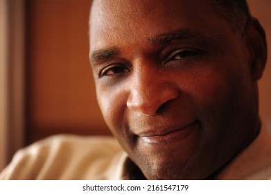 Close Up Of A Smiling Clean Shaven 60 Year Old African American Man