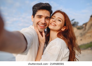 Close up smiling happy young couple two family man woman 20s in white clothes hug each other do selfie shot pov on mobile phone at sunrise over sea beach outdoor seaside in summer day sunset evening - Powered by Shutterstock