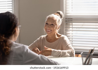 Close Up Smiling Mature Woman And Doctor Discussing Successful Treatment Or Medical Checkup Results At Meeting In Hospital Office, Old Patient Consulting With Therapist Physician, Health Insurance