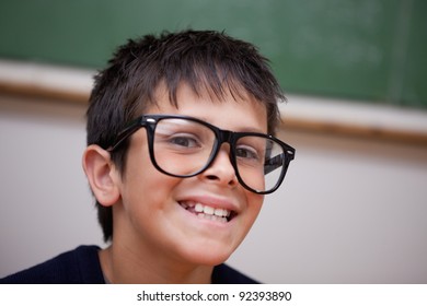 Close up of a smiling schoolboy in a classroom