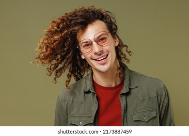 Close Up Smiling Young Brunet Curly Man 20s Wears Khaki Shirt Jacket Glasses Dance Waving Fooling Around Have Fun Enjoy Play Fluttering Hair Isolated On Plain Olive Green Background Studio Portrait