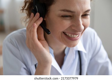 Close Up Smiling Young Woman Doctor Wearing Headset With Microphone Working Online, Friendly Therapist Physician Gp Wearing White Coat Uniform Consulting Patient, Telemedicine Service, Video Call