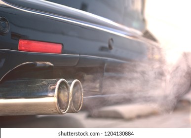 Close Up Of Smoky Dual Exhaust Pipes From A Starting Diesel Car - Emissions Scandal.