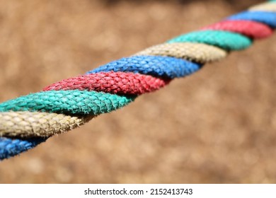 Close Snapshot Of Multicolored Rope On A Light Brown Background.