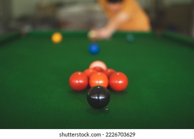 A close up of snooker ball, black and set up of red balls. Concept of playing activity, entertainment leisure, billiards, snooker or pool ball. Blue chalk. Hobbies and lifestyles.