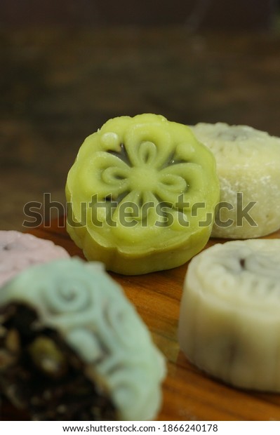 Close up\
of Snow Moon Cake or Kue Bulan as celebration cake for mid autumn\
festival for Chinese tradition. Oriental pattern on cake\'s surface,\
copy space on dark blurred\
background