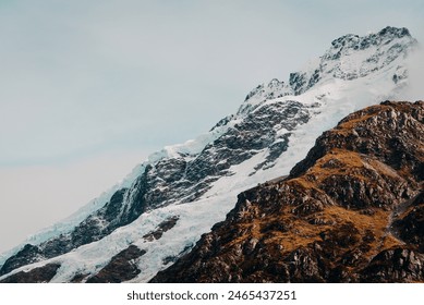 Close Up of Snow-Covered Mountain Range With Brown Grass Snow Capped Misty Fog Cloudy - Powered by Shutterstock