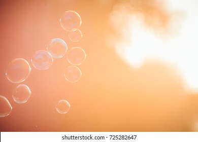 Close up Soap bubbles into the sunlight with beautiful bokeh. - Shutterstock ID 725282647