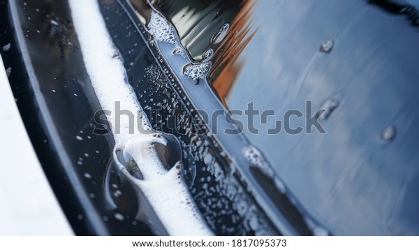 Close up of\
soap lather on modern car\
windshields