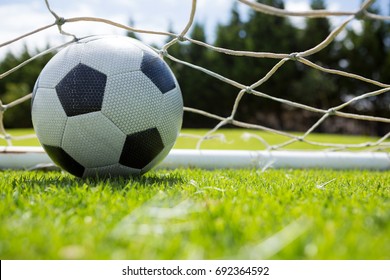 Close Up Of Soccer Ball In Goal Post At Field