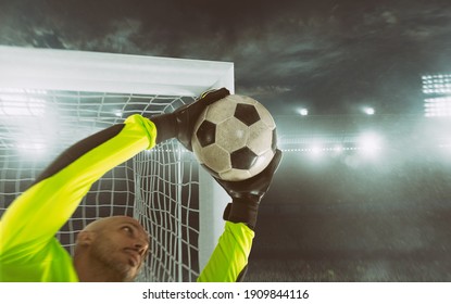 Close up of a soccer goalkeeper saving the ball at the corner of the goalposts - Powered by Shutterstock