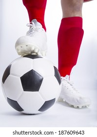 Close up soccer player use foot touch on the top of football