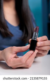 Close Up Of Social Media Influencer Holding Lipstick While Recording Make Up Review For Vlogging Channel In Studio. Blogger Content Creator Filming Cosmetics Tutorial Advertising Product
