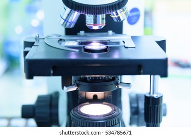 Close up and soft focus of objective lens microscope in laboratory.Blue tone. - Powered by Shutterstock