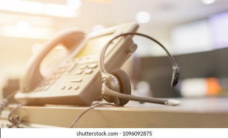 Close Up Soft Focus On Telephone Devices At Office Desk Of Customer Service Support Concept