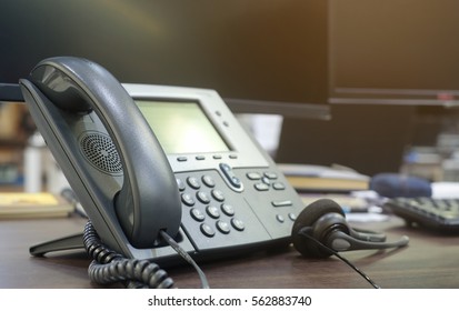 close up soft focus on telephone devices at office desk for customer service support concept