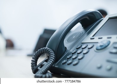 close up soft focus on telephone devices at office desk with light effect,communication technology concept