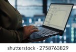 Close up of software developer working in data center to optimize network infrastructure. Programmer in server farm diagnosing and resolving equipment malfunctions using device