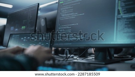 Close Up of a Software Developer Working on a Desktop Computer, Programming Code Running on Display. Specialist Typing on Keyboard, Coding and Implementing a Technical Feature