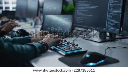 Close Up of a Software Developer Working on a Desktop Computer, Programming Code Running on Display. Specialist Typing on Keyboard, Coding and Implementing a Technical Feature, Working in an Agency