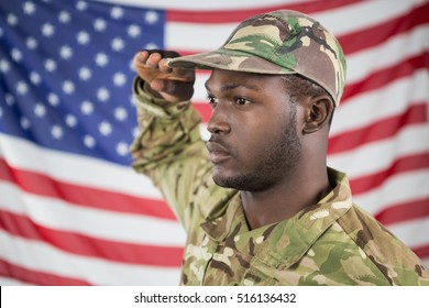 Close- Up Of Soldier Saluting Against American Flag