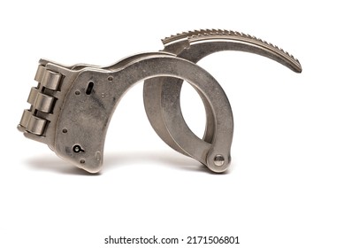 Close Up Of Solid Iron Metal Steel Handcuffs With Rigid Solid Fixed Hinge And Open Locking Bars Pointing Upwards On White Background