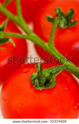 close up of some  cherry tomatoes isolated over white