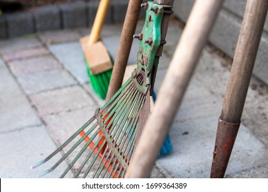 Close Up Of Some Gardening Tools. Focused On A Rake. Tools To Clean Up A Garden.