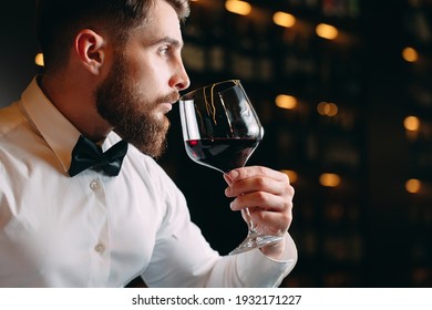 Close Up Of Sommelier Man Sniffing Wine In Glass