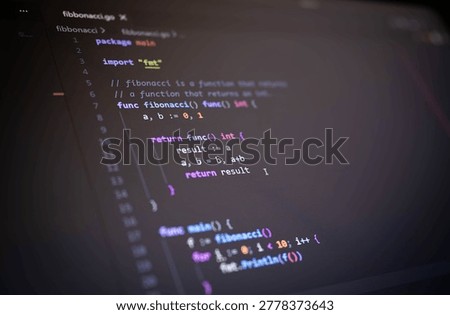 Close up of source code on computer monitor with colorful syntax highlighting and dark atmosphere, representing software engineering, programming, cybersecurity, web development and modern digital technology.