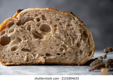 Close up sourdough artisan homemade bread sliced in halfs on dark background - Shutterstock ID 2131804633