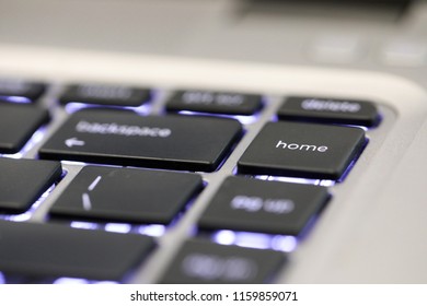 close up of the special computer key board button home. illuninated contemporary modern keyboard character. 