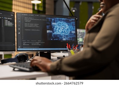 Close up of IT specialist in tech startup using artificial intelligence on PC to optimize performance and forecast issues. Technician in office training deep learning models using computer