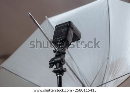 close up of speedlight and diffuser umbrella