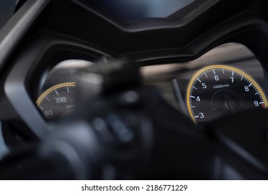 close up of speedometer, tachometer. motorcycle, motorbike, bigbike. dashboard detail with indication lampe. fuel level gauge. motor speed control 1000 rpm-min. in garage view soft focus and lens flar