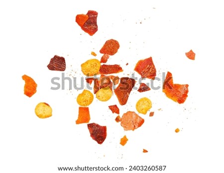 Close up spicy chili red pepper flakes, chopped, milled dry paprika pile isolated on white 