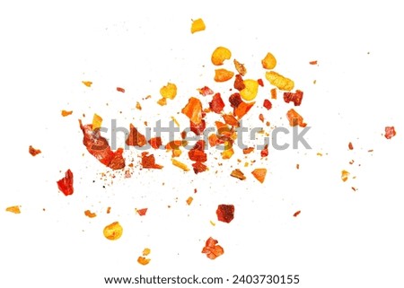 Close up spicy chili red pepper flakes, chopped, milled dry paprika pile isolated on white