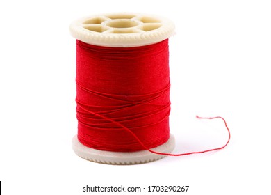 close up of a spool of red sewing thread isolated on white