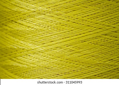 Close Up Of A Spool Of Synthetic Green Thread