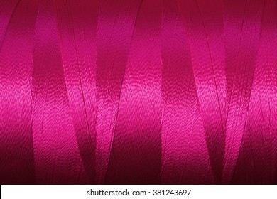 Close Up Of A Spool Of Synthetic Pink Thread