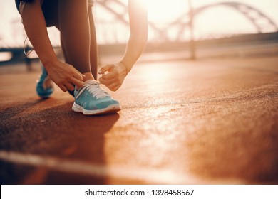Close up of sporty caucasian woman kneeling and tying shoelace on court in the morning. Sometimes the best runs come on days you didn’t feel like running.